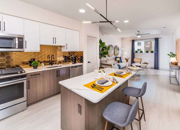 Bronze finish model kitchen with sleek appliances at Avel Apartment Homes in Orange CA