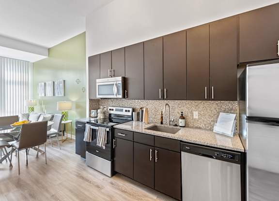 Kitchen with mocha cabinets at Bradley Braddock Road Station Apartments in Alexandria VA