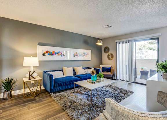 Living room with wood style flooring at Kaleidocope Apartment Homes in Las Vegas NV