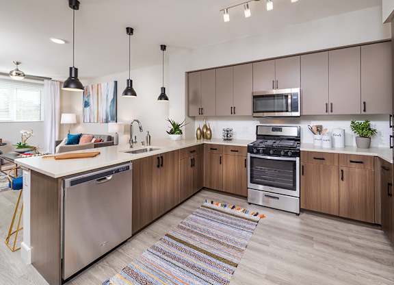 Kitchen with brown cabinets at Altitude Apartments in South San Francisco CA