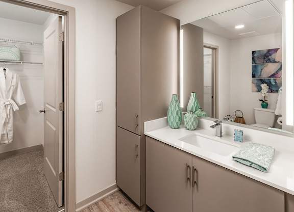 a bathroom with a sink and a mirror at Norte Town Lake Apartments in Tempe Arizona