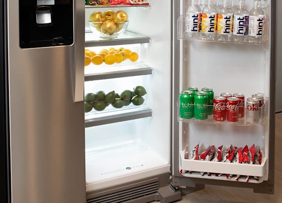 Model Pewter Kitchen Fridge Open at Chroma Apartment Homes in Canoga Park CA