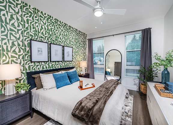 Bedroom with green accent wall at The Brynn in Kirkland WA