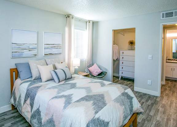 a bedroom with a bed and a mirror and a closet