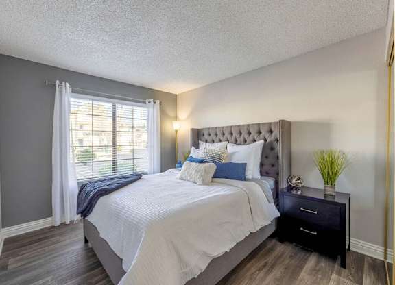 Bedroom with wood style flooring at Kaleidocope Apartment Homes in Las Vegas NV