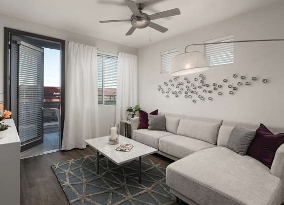 Model apartment living room with ceiling fan at Norte Town Lake Apartments in Tempe Arizona