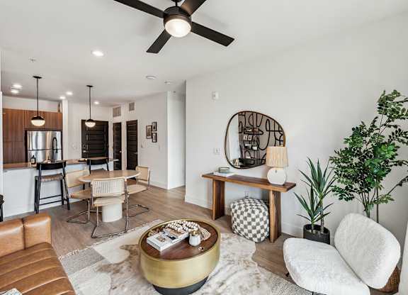 A living room with a brown leather couch and a coffee table.