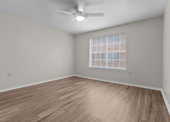 Modern Bedroom with ceiling fan at Valley Ridge Apartments in Lewisville TX