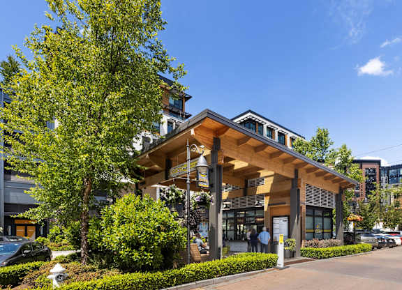 A modern building with a wooden facade and glass windows.