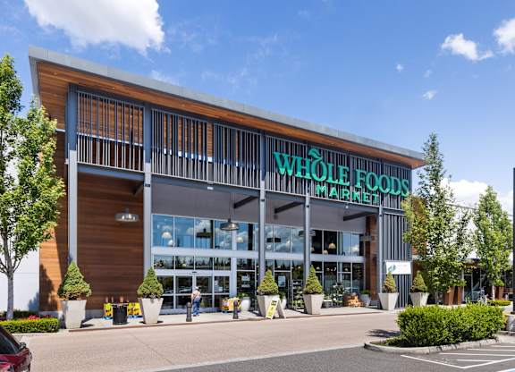 A Whole Foods Market store with a parking lot in front.