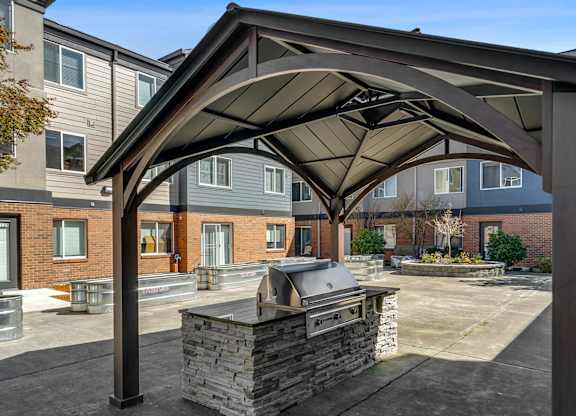 Outdoor patio with grill at Auburn Court Apartments in Auburn WA
