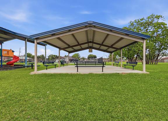 A park with a canopy and benches.