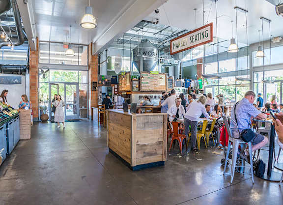 A group of people are sitting at tables in a restaurant