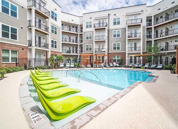 Outdoor pool and tanning chairs at The Belhaven in Alexandria VA