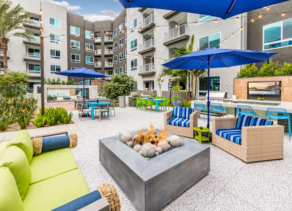 Pool with fire table and lounge seating at Avel Apartment Homes in Orange CA