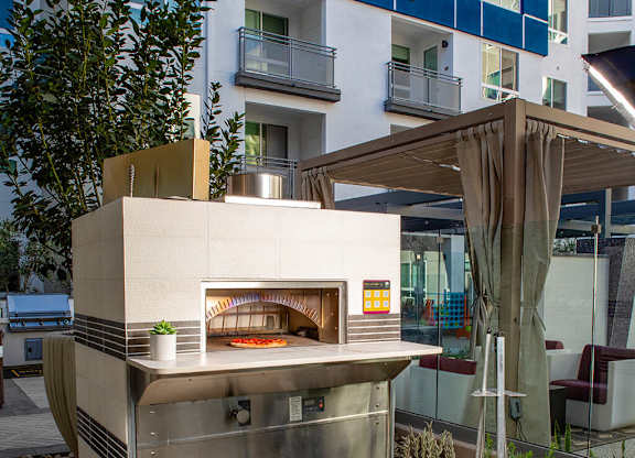 Pool Luminescence Pizza Oven with Pizza at Chroma Apartment Homes in Canoga Park CA