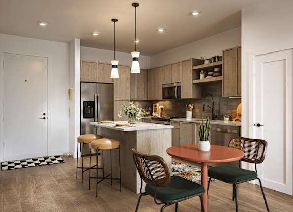 A kitchen with a table and chairs in the foreground and a bar area in the background.