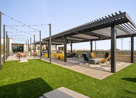 A patio with a roof and chairs.