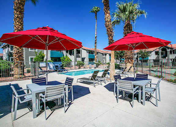 our apartments have a pool and tables with umbrellas