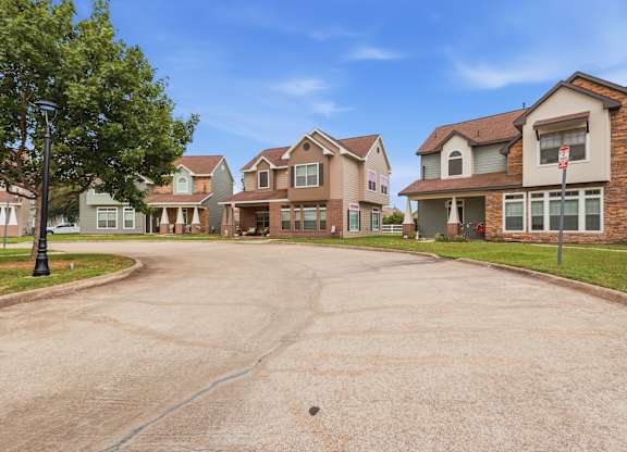 A residential area with houses and a tree.