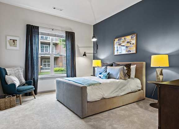 Model bedroom with large window at The Slate at Andover Apartments in Andover MA