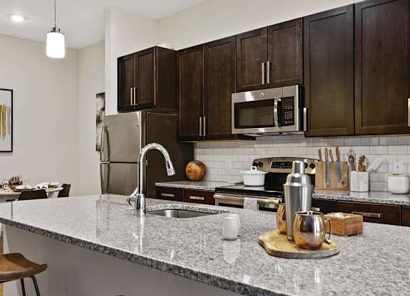 Kitchen with white countertops at The Slate at Andover Apartments in Andover MA