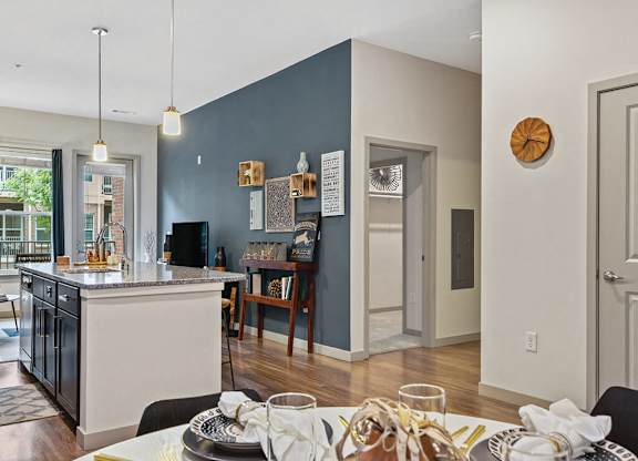 View of living room with kitchen at The Slate at Andover Apartments in Andover MA