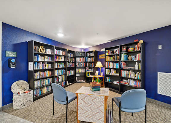 Social lounge reading area at Woodlands at Forbes Lake Apartments in Kirkland WA