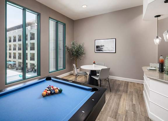 Social lounge game area at Caprielle Apartments in San Diego CA