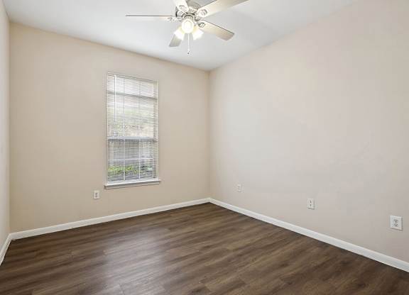 Bedroom with wood flooring at Fountains at Tidwell and The Enclave in Houston TX
