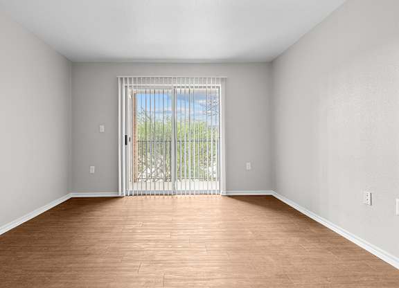 Traditional living room with patio access at Valley Ridge Apartments in Lewisville TX