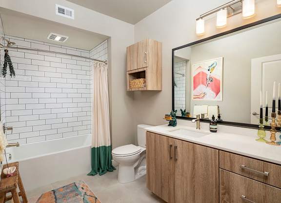 Bathroom with dual sinks at Rivair Apartment Homes in San Diego CA