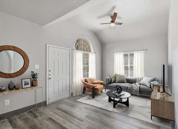 Living room with ceiling fan at Almeda Park Apartments in Houston TX