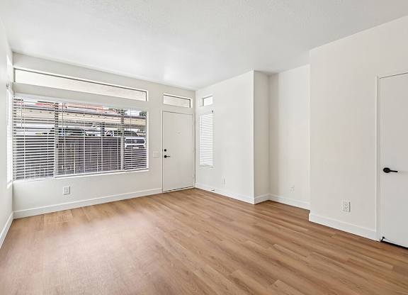 A room with wooden floors and white walls.