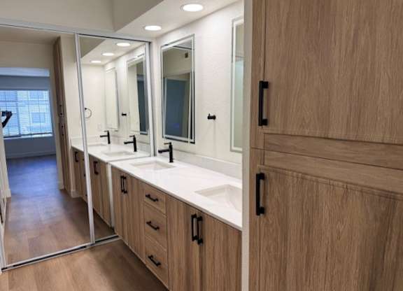 A bathroom with a vanity and a mirror.