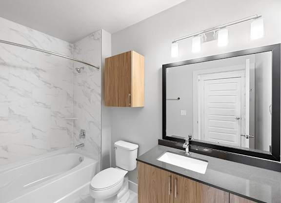 Herringbone Design Package Bathroom at East Bend Apartments in Houston TX