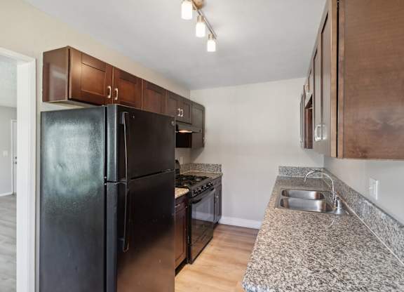 Kitchen with black appliances at Park Crest Apartments in San Diego CA
