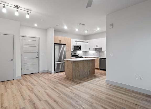 Vacant living room and kitchen at VERO Apartments in Chelsea MA