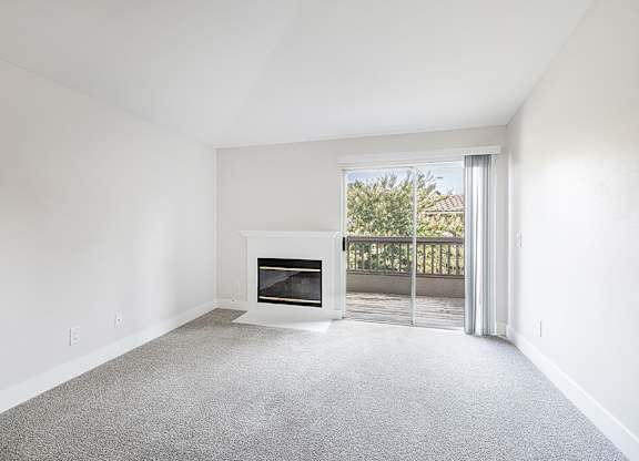 Living room with fireplace at Deerwood Apartments in Corona CA