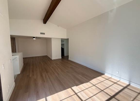 A room with wooden floors and white walls.