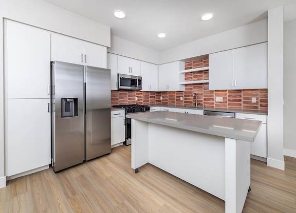Vacant Metallic Rose Design Package Kitchen at Bowen Apartments in San Diego CA