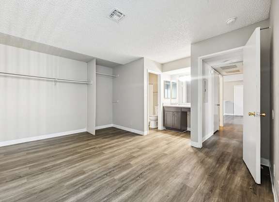 Vacant Primary Bedroom and Bathroom at Woodcreek Apartments in Las Vegas NV