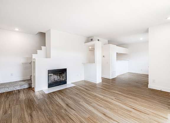 Living room with fireplace at Marquessa Villas Apartmetns and Townhomes in Corona CA 