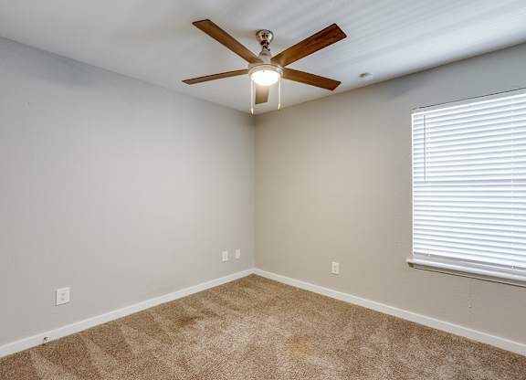 Second bedroom with carpet at Mission James Place Apartments in Austin TX