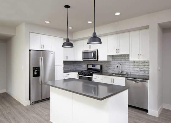 Vacant Slate Design Package Kitchen with island at The Seaton Apartments in San Diego CA