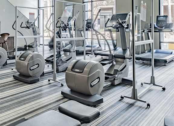 A gym with treadmills, elliptical machines, and other cardio equipment.