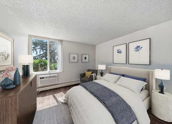 Bedroom with bed and digitally staged furniture at Ridgemoor Apartment Homes in Lakewood CO