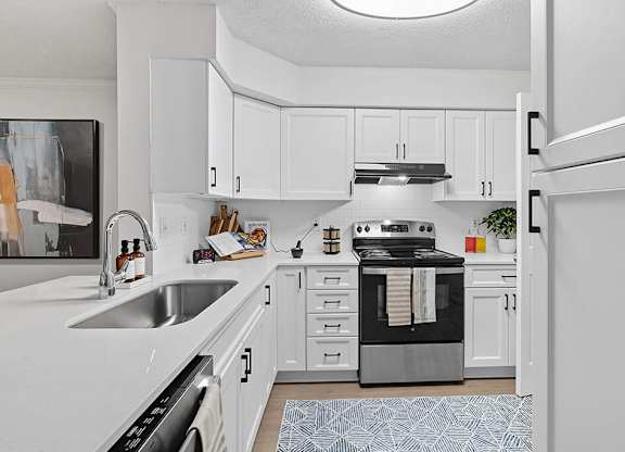 Kitchen with white shaker cabinets at Chroma Park Apartments in Austell GA