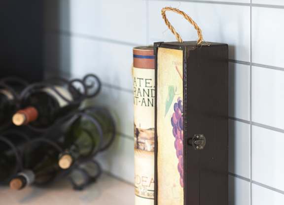 A book with a gold ribbon bookmark sits on a countertop.