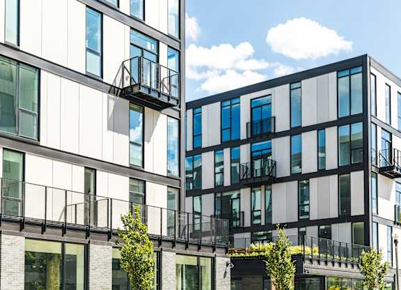 A modern building with balconies and glass windows.